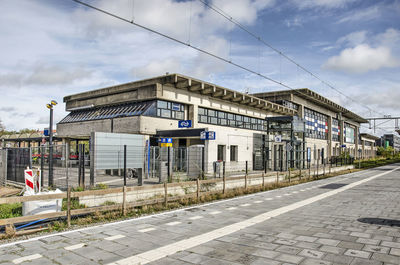 Railroad station by building against sky