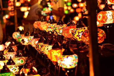 Close-up of lit candles in the dark