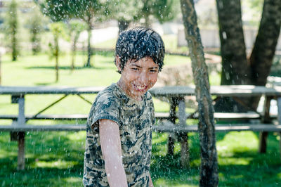 Portrait of smiling man splashing water