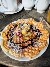 Waffle with chocolate sauce and a fruit