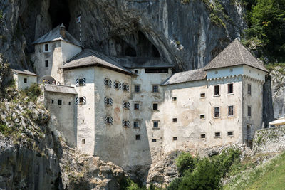 Low angle view of old buildings and tree