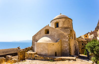 Old ruins of building against clear blue sky