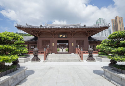 View of temple building against cloudy sky