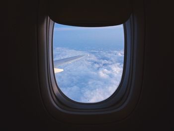 Aerial view of clouds seen through airplane window