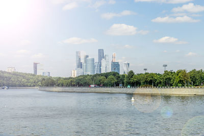 View of buildings in city against cloudy sky