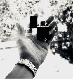 Close-up of woman photographing with mobile phone