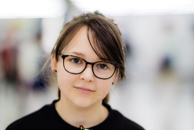 Close-up portrait of confident teenage girl wearing eyeglasses