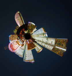 Low angle view of illuminated ferris wheel against sky at night