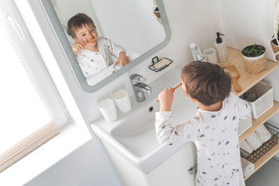 High angle view of woman sitting in bathroom