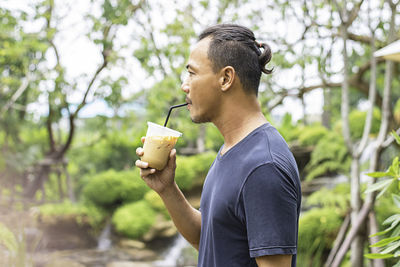 Side view of man drinking coffee