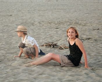 Portrait of smiling young woman sitting on beach