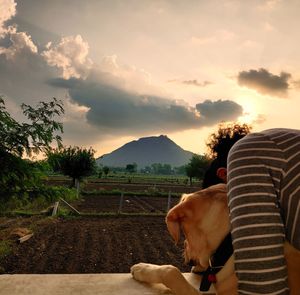 View of a dog on landscape against sky