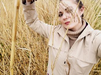 Portrait of woman standing on field