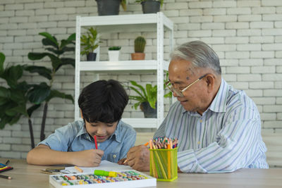 Portrait of boy sitting on table