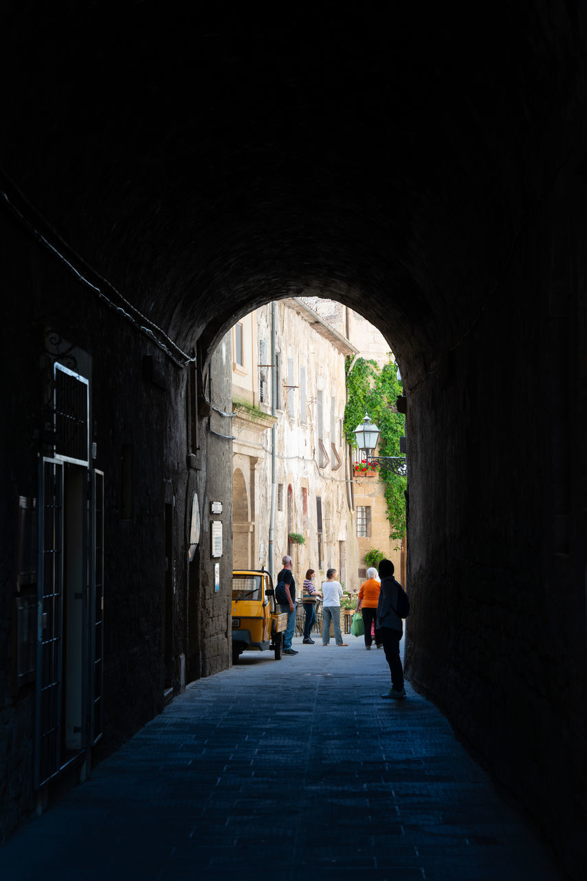 PEOPLE WALKING ON CORRIDOR OF BUILDING