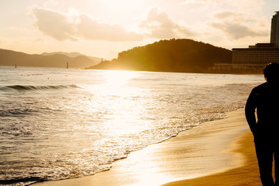 Silhouette of man at beach during sunset