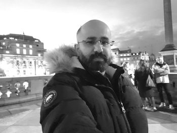 Portrait of man with city in background