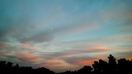 Silhouette of trees against sky at sunset