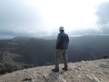 Rear view of woman standing on landscape