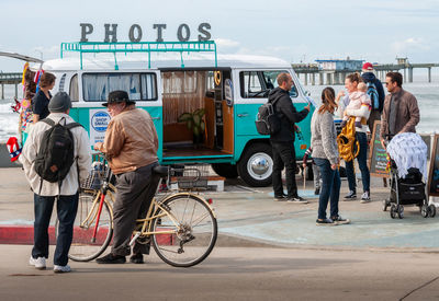 People with bicycle on road in city