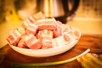 Close-up of raw pork in plate on table