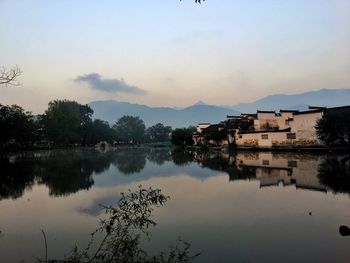 Scenic view of lake against sky at sunset