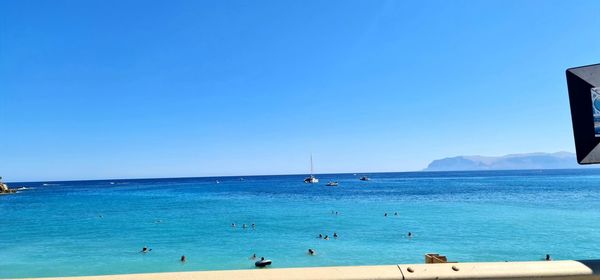 Scenic view of sea against clear blue sky