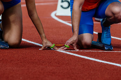 Low section of woman exercising on field