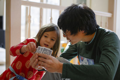 Father and daughter playing a game of cards at home