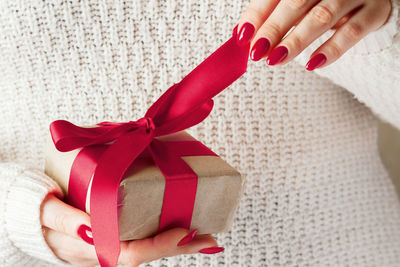 Cropped hand of woman holding gift