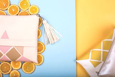 Directly above shot of purses with orange slices on table