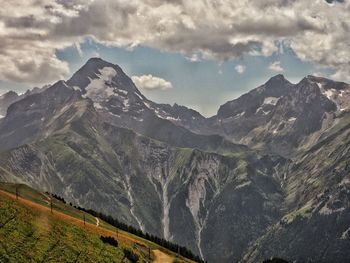 Scenic view of snowcapped mountains against sky