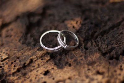 Close-up of wedding rings on ground