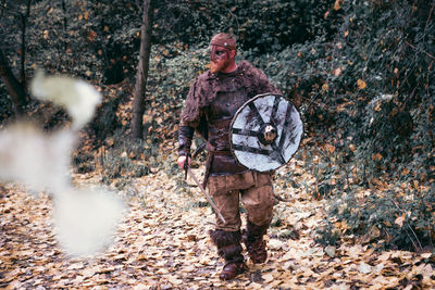 Full length of man standing in forest