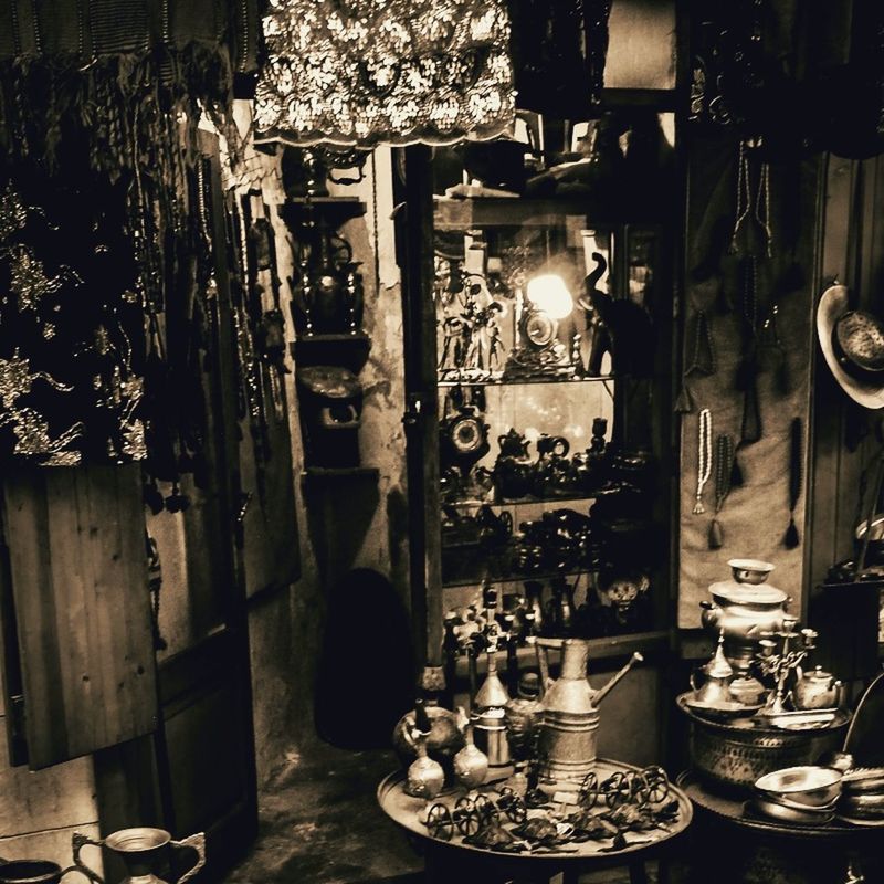 table, indoors, illuminated, wood - material, chair, large group of objects, arrangement, abundance, in a row, night, restaurant, absence, lighting equipment, no people, still life, variation, shelf, potted plant, house, order