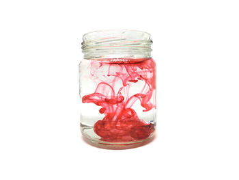 Close-up of glass jar against white background