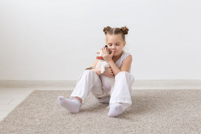 Young woman eating food on floor