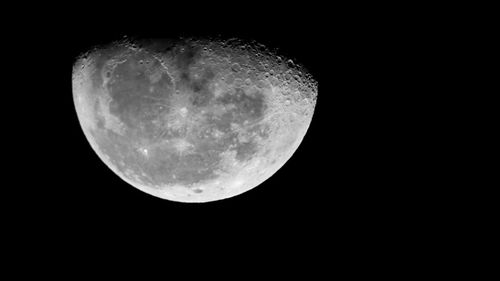 Low angle view of moon against sky at night