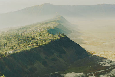 Scenic view of landscape and mountains against sky 