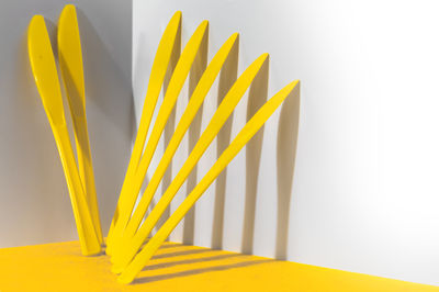 Seven bright yellow plastic knives