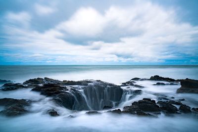 Scenic view of sea against cloudy sky