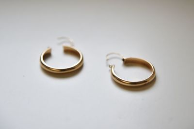 Close-up of wedding rings on metal against white background