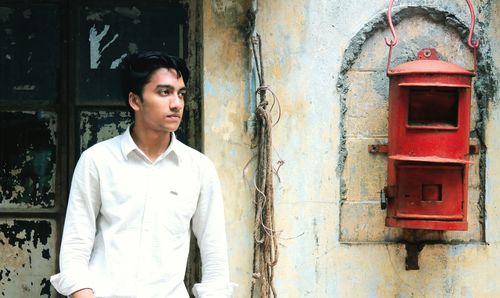 Thoughtful man looking away while standing outdoors