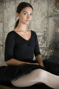 Portrait of young woman sitting at home