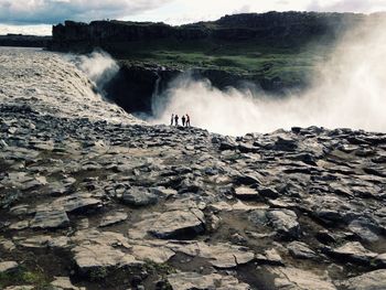 Scenic view of waterfall against rocks