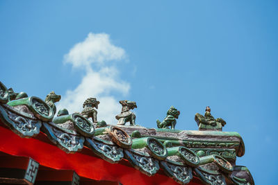 Low angle view of statue against blue sky