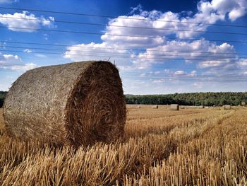 Scenic view of field against cloudy sky