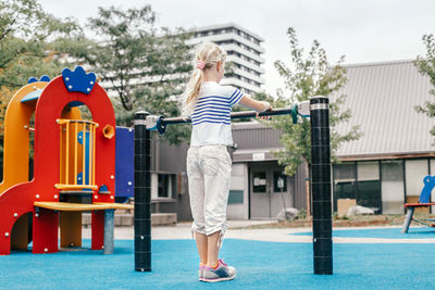 Rear view of girl playing at playground