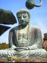 Low angle view of statue against temple