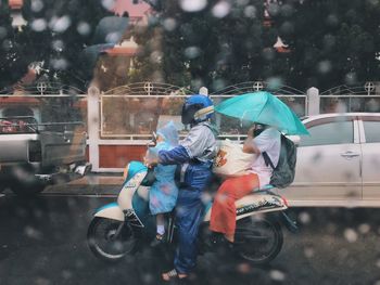 People on wet street during monsoon